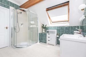 a bathroom with a shower and a sink at MOONGATE by BOURNECOAST - A Delightful Chalet Bungalow with a Garden and Parking - HB10672 in Christchurch +64 photos