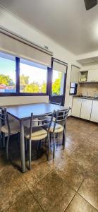 a dining room with a table and two chairs at Aqua Terra in Federación +29 photos