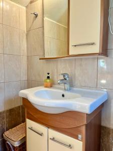 a bathroom with a sink and a mirror at Nomads in the south in Tsoútsouros