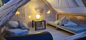 a room with two beds and a table in a tent at Lighthouse Benki in Užava +74 photos