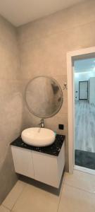 a bathroom with a round sink on a counter at ZEYD VillA in Gabala
