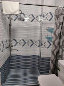 a bathroom with a shower with a shower curtain at Fam Guest House in Samarkand