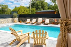 a group of chairs and a swimming pool at Villa Aurelia Wellness Bihać in Bihać