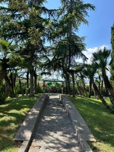 a path in a park with trees and grass at Hotel Giovanna in Pompei