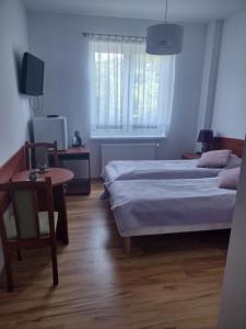 Pokoje Gościnne u Oli客房内的一张或多张床位