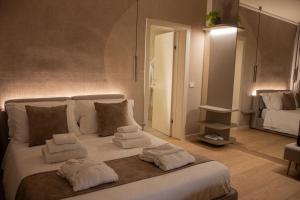 a bedroom with a large white bed with towels on it at B&B Villa Margherita - Luxury Rooms in Padua in Padova