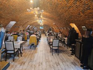 a restaurant with people sitting at tables in a tunnel at La Opt Apartments in Oradea