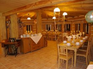 a dining room with a long table and chairs at Penzion Marienka in Pec pod Sněžkou