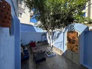a patio with a tree in front of a door at Jb house in Chefchaouen