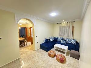 a living room with a blue couch and a table at Jb house in Chefchaouen