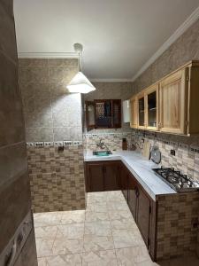 a kitchen with a sink and a stove at Jb house in Chefchaouen +6 photos
