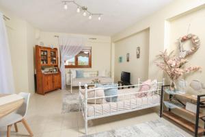 a living room with a baby crib and a bedroom at The Blue Horizon House in Afitos