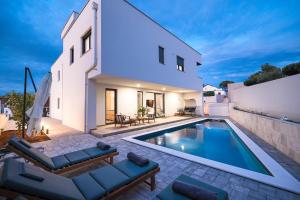 a villa with a swimming pool and a house at Vila Zara365 in Zadar