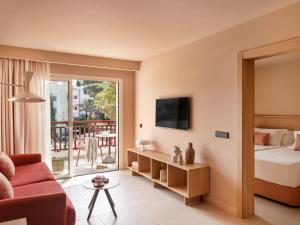 a hotel room with a bed and a balcony at Inturotel Esmeralda Park in Cala d´Or +73 photos