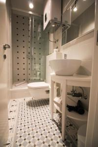 a bathroom with a sink and a shower and a toilet at Luxury living Apartments in Split