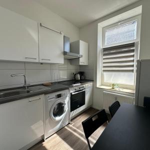a kitchen with a washing machine and a sink at WDI - WorkersSpace in Bochum