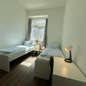 a room with two beds and a window at WDI - WorkersSpace in Bochum