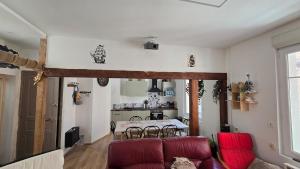 a living room with a red couch and a table at Appartement plage & port in Le Tréport