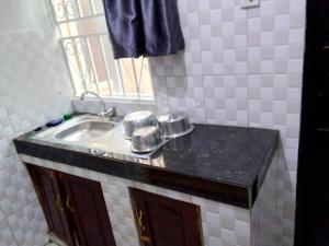 a bathroom with a sink and a mirror at CTS Suites in Kampala