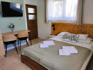 Posteľ alebo postele v izbe v ubytovaní Apartamenty Milka