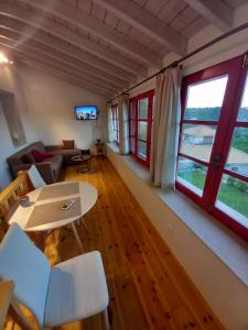 a living room with a couch and a table at Sweet Red Home in Asprogerakata