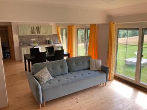 a living room with a couch and a kitchen at Apartmány2 - Náhlov in Frymburk