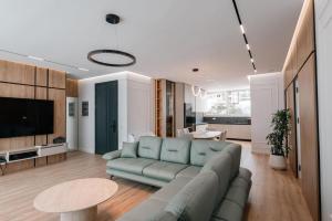 a living room with a couch and a table at Skyline penthouse Sarande in Sarandë