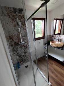 a bathroom with a glass shower with a sink at Casa de Santa Luzia in Vila Praia de Âncora