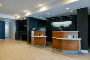 a lobby with a barber shop with wooden counters at Courtyard by Marriott North Charleston Airport Coliseum in Charleston