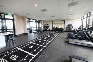 a gym with treadmills and exercise equipment in a building at Van der Valk Hotel Den Haag in Nootdorp