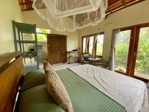 a bedroom with a large bed in a room with windows at Hello Homestay in Galle