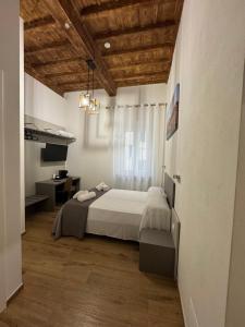 a bedroom with a bed and a desk in it at San Giovanni Rooms Livorno in Livorno