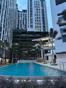 a large swimming pool in a city with tall buildings at Minimalist Living , One bedroom in Phnom Penh