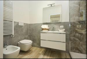 a bathroom with a sink and a toilet and a mirror at Residenza il Bruco N 3, 300 meters from the subway in Cernusco sul Naviglio +21 photos