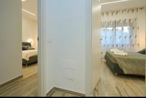a bedroom with a bed and a mirror in a room at Residenza il Bruco N 3, 300 meters from the subway in Cernusco sul Naviglio