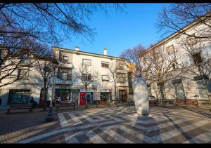 a statue in a courtyard in front of a building at Residenza il Bruco N 3, 300 meters from the subway in Cernusco sul Naviglio