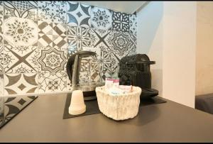 a kitchen counter with a sink and a faucet at Residenza il Bruco N 3, 300 meters from the subway in Cernusco sul Naviglio