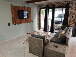 a living room with a couch and a tv at Duikertjie in Groblersdal