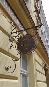 a sign hanging on the side of a building at Lovely Prague Havanska in Prague