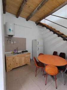 a kitchen with a table and chairs in a room at Hostel Sol in Santa Fe