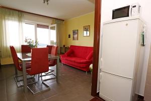 a living room with a table and a red couch at Apartment Boni in Šibenik