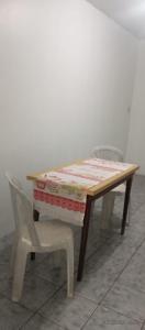a table and a chair with a quilt on it at Apartamento para FIG 2 in Garanhuns