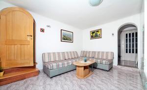 a living room with a couch and a table at Apartment Belici in Brseč