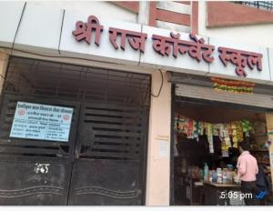 a man is standing outside of a store at Shri Raj Home stay in Ujjain