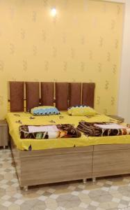 a bedroom with two beds with yellow sheets at Shri Raj Home stay in Ujjain