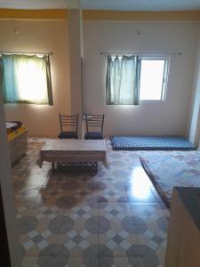 a room with two beds and a bench in it at Shri Raj Home stay in Ujjain