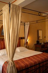 a bedroom with a bed with a canopy at Hotel Botticelli in Maastricht +21 photos