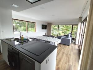 a kitchen and living room with a couch and a table at Casa de Santa Luzia in Vila Praia de Âncora