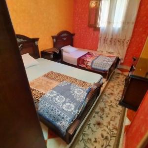 Postel nebo postele na pokoji v ubytování Casa Cleopatra Piramidi