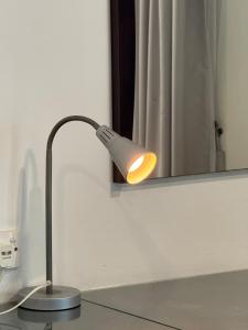a lamp sitting on a counter in front of a mirror at Deluxe Room for 2 Pax - Central of Kuching in Kuching
